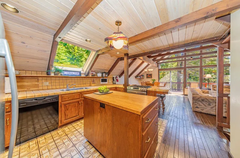 The kitchen and its island, topped with a solid oak cutting board