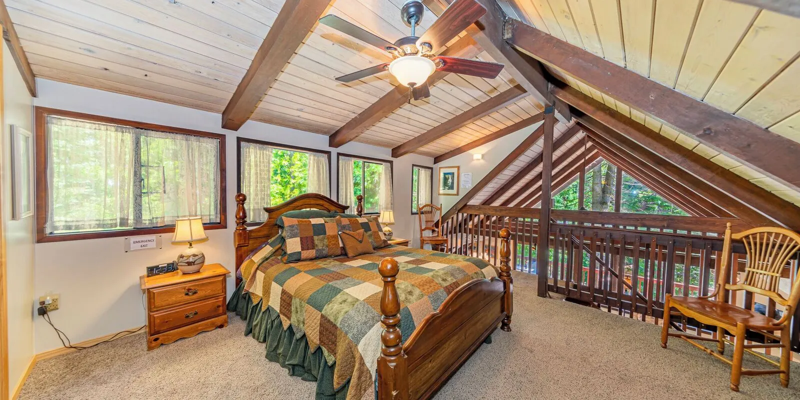 The top floor: a bedroom of its own under the roof's beams, with its own bathroom